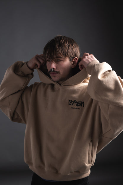 SYREN hoodie with relaxed streetwear fit – male model adjusting hood
